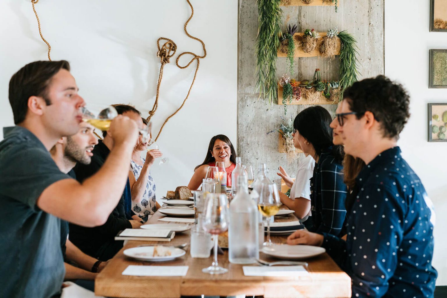 Friends at dining table drinking wine